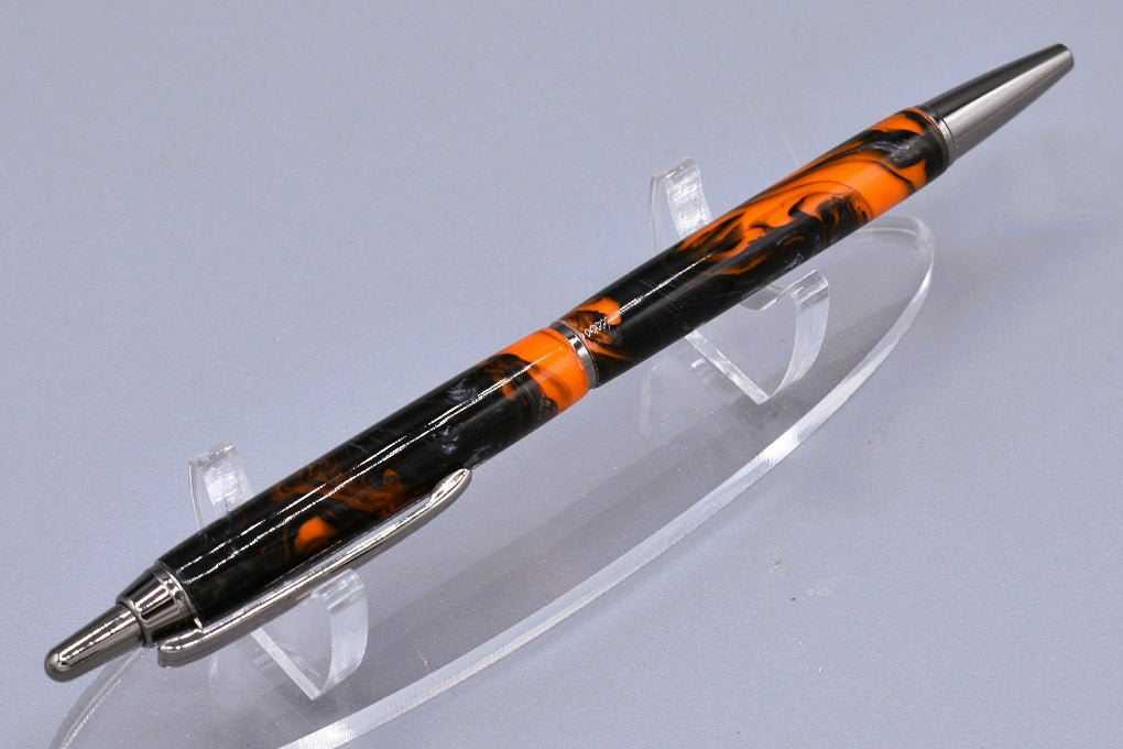 Handmade Slim click pen. Black, orange & silver resin.