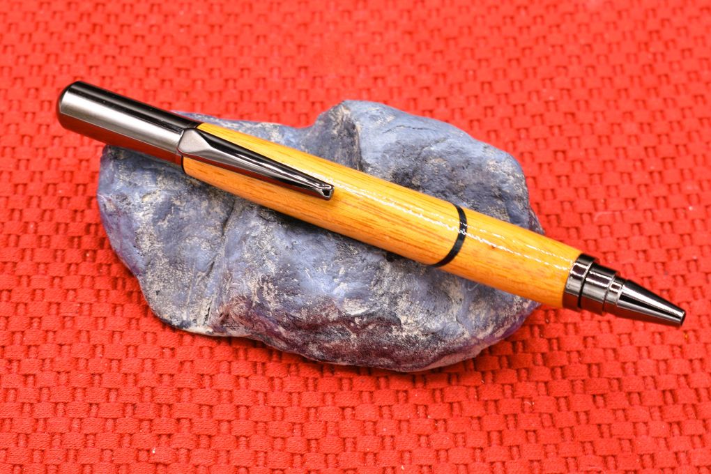 Handmade Click capped rollerball pen. Osage Orange and blue veneer woods.