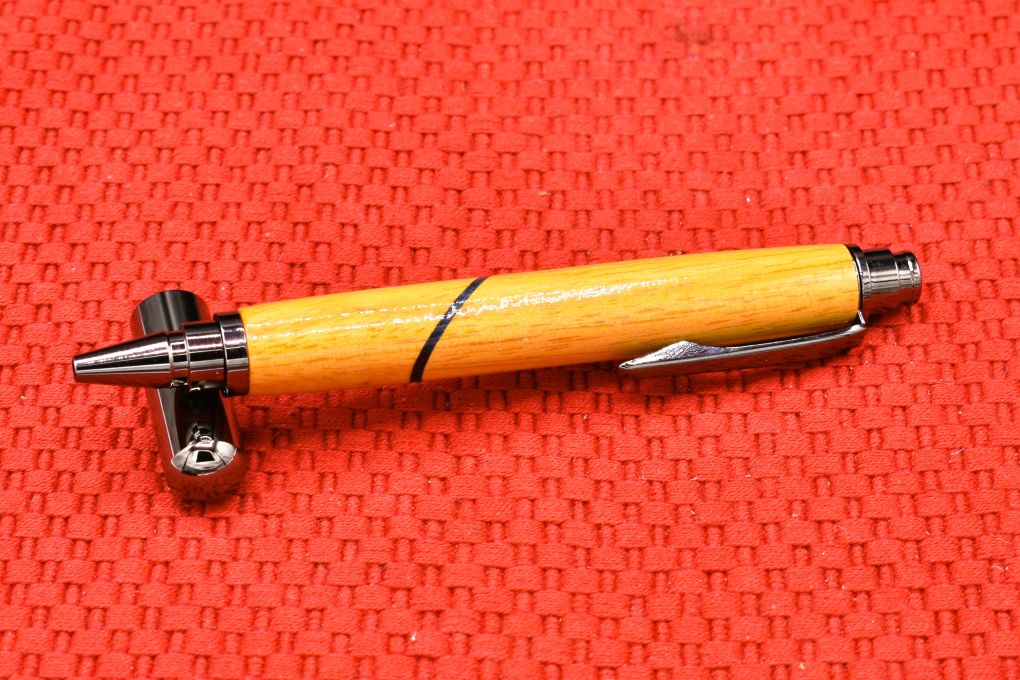 Handmade Click capped rollerball pen. Osage Orange and blue veneer woods.